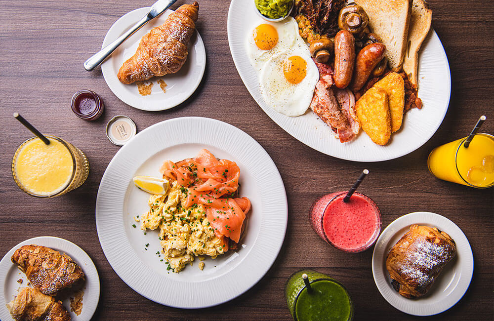 Breakfast spread: full English, smoked salmon scrambled eggs, pastries and juices